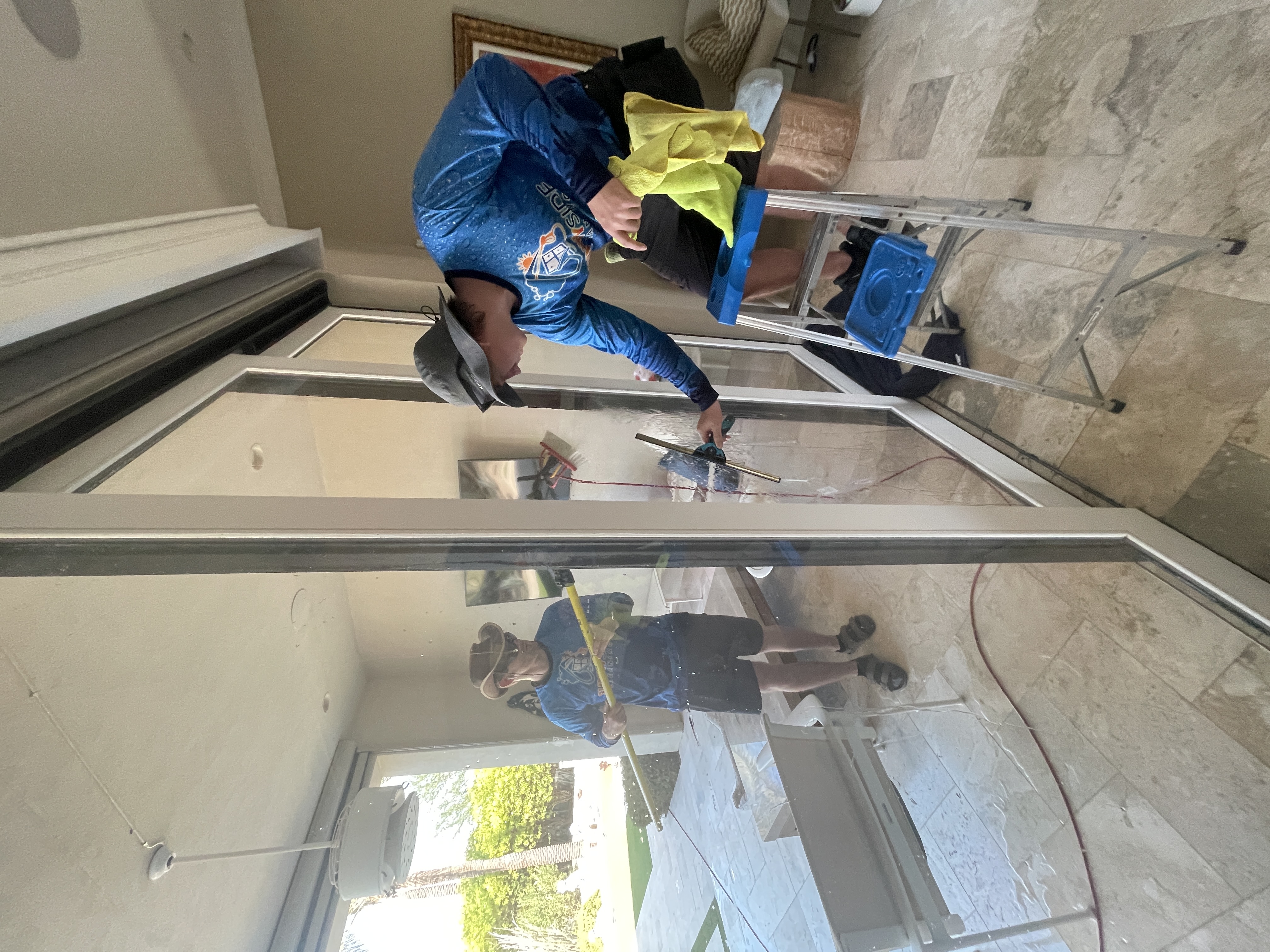 Sunny Side Cleaning technicians cleaning large residential windows
